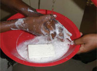 Someone washing their hands in soap and water.