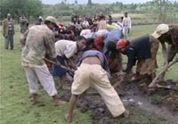 Community members digging a ditch.