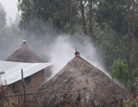 Smoke from indoor cooking fires escaping through the roof