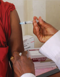 Someone being given an injection in the arm.