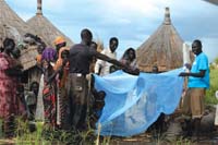 A health professional demonstrates how to use the bed net.