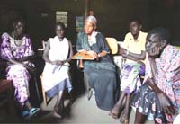 Women gathered around listening intently.