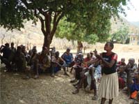 A woman leads a discussion amongst the community.