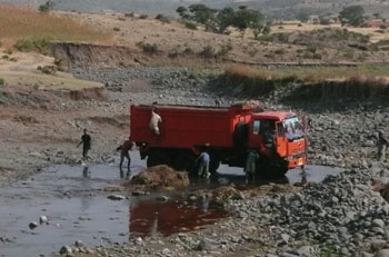 Washing a lorry in the river