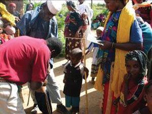 Health professional doing height screening